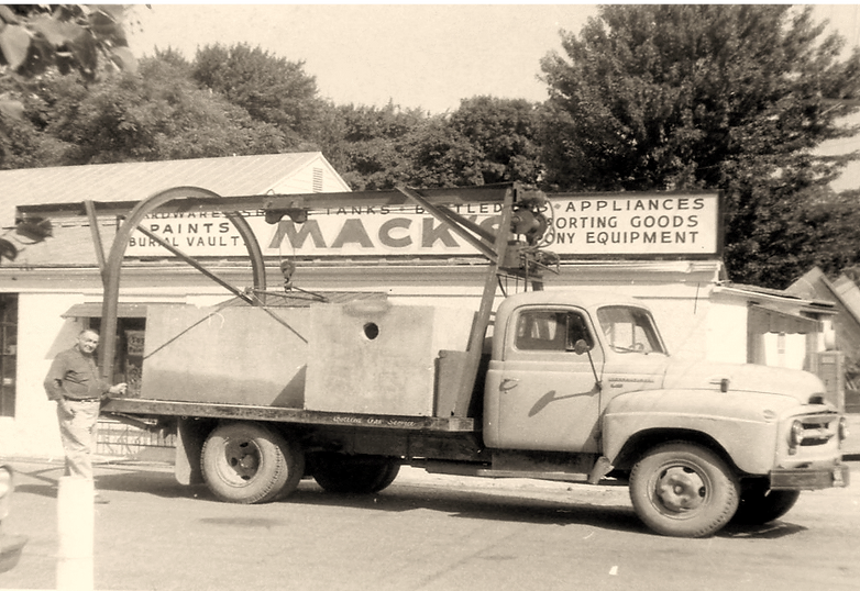 1950s era flatbed truck loaded with mack precast concrete products